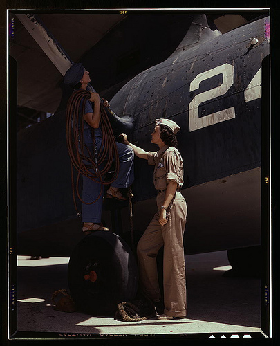 Women are contributing their skills to the nation's needs by keeping our country's planes in top-notch fighting condition, Corpus Christi, Texas. Wife of a disabled World War I veteran, Mrs. Cora Ann Bowen (left) works as a cowler at the Naval Air Base. M